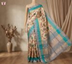 Ivory Silk Saree with Stylized Floral Motifs and Teal–Grey Gold Zari Border