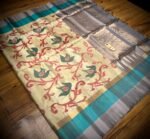 Ivory Silk Saree with Stylized Floral Motifs and Teal–Grey Gold Zari Border