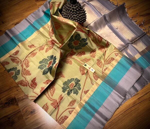 Pista Green Floral Silk Saree with Gold Zari Border and Teal Highlights