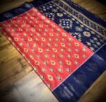 Vermilion Red & Royal Blue Satin Saree with Ikat Motifs and Zari Peacock Border