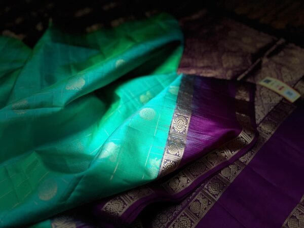 Sea Green Kanchipuram Silk Saree with Gold Zari Buttas and Royal Purple Contrast Pallu