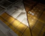 Elegant White Silk Saree with Gold Zari Buttas & Rich Yellow Pallu